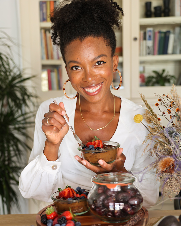 Jenné Claiborne holding a dish of vegan chocolate mousse. 