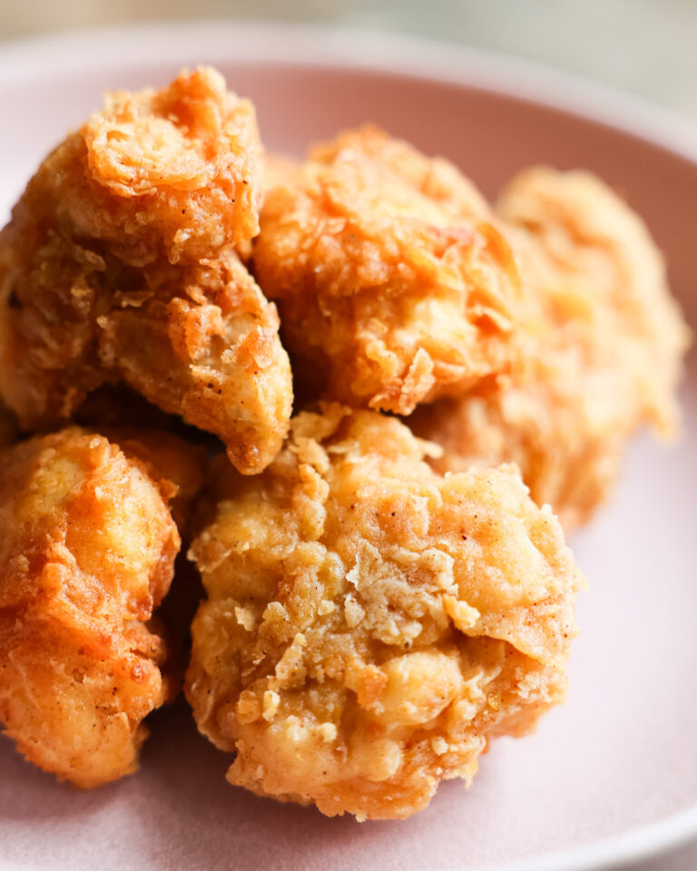 Closeup of vegan fried chicken on pastel purple plate