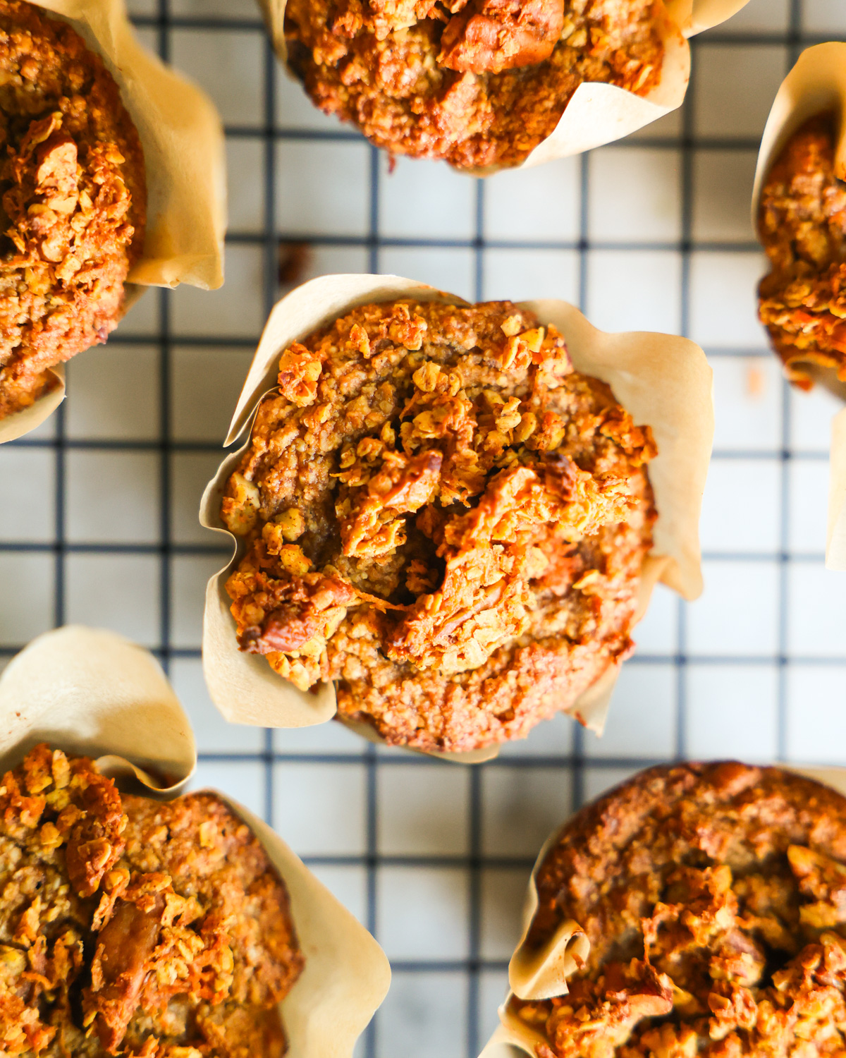 An overhead shot of the oat bran muffins with sweet potato cooling on a rack.