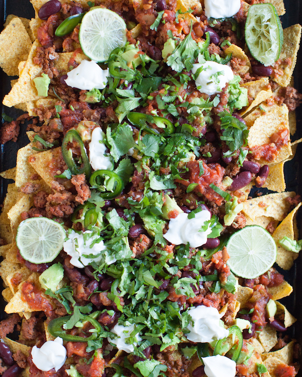 overhead of vegan nachos served on a baking sheet