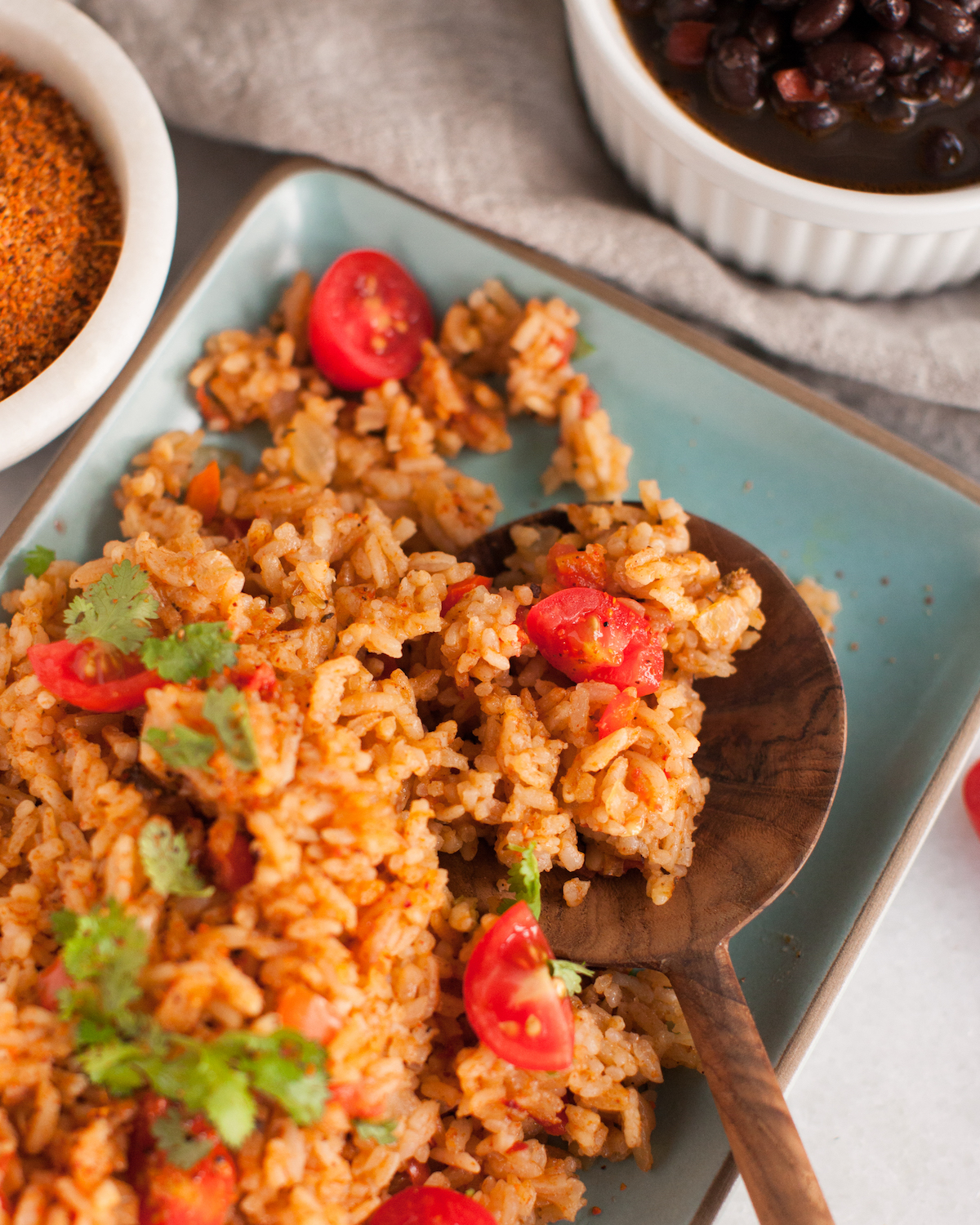 Instant Pot Mexican Rice on a plate with wooden spoon