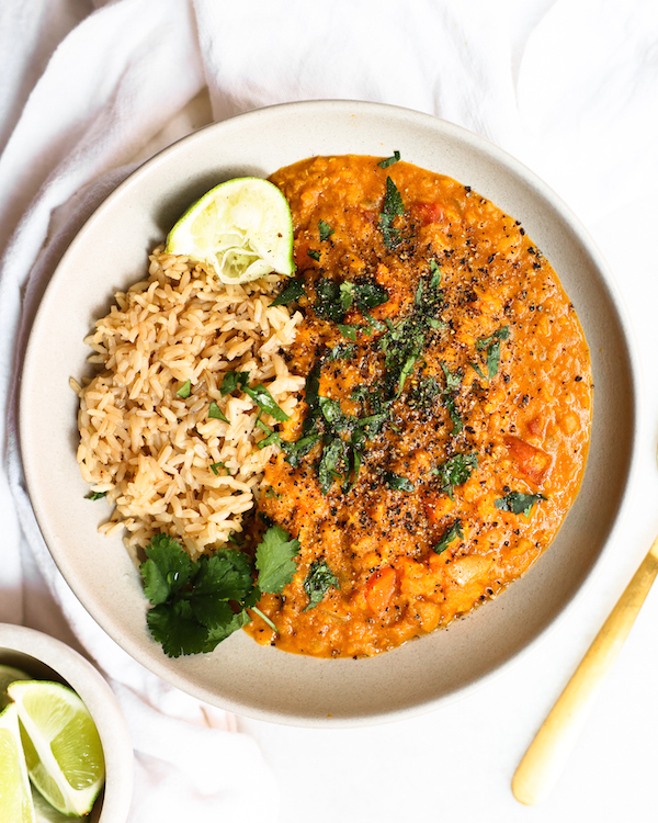red lentil curry with brown rice, as well as  lime and cilantro garnishes