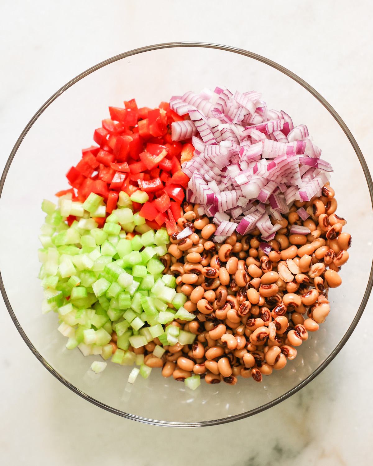 Black eyed pea salad ingredients in a bowl.