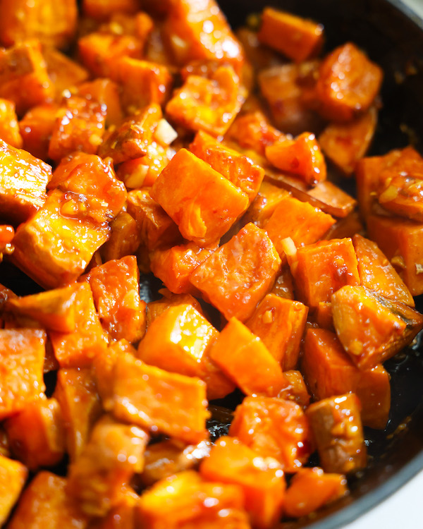 Glazed sweet potatoes in a black cast iron skillet