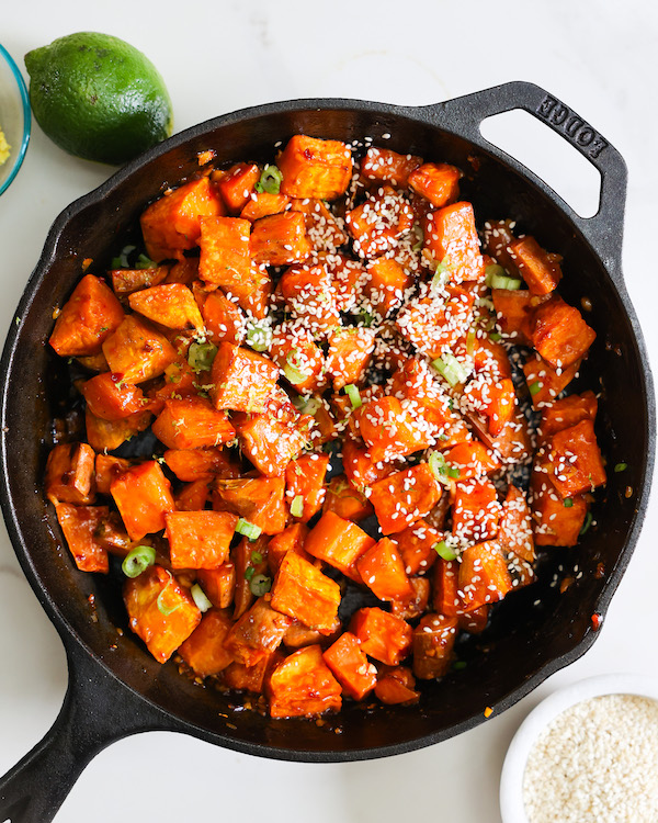 chili lime glazed sweet potatoes served in a cast iron skillet. 