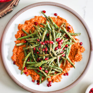 Air fryer green beasn and muhammara on a plate.