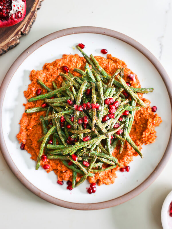 Air fryer green beasn and muhammara on a plate.