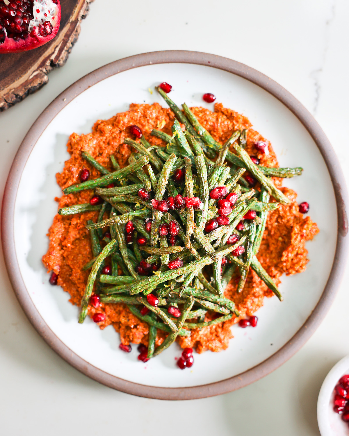 Air fryer green beasn and muhammara on a plate.