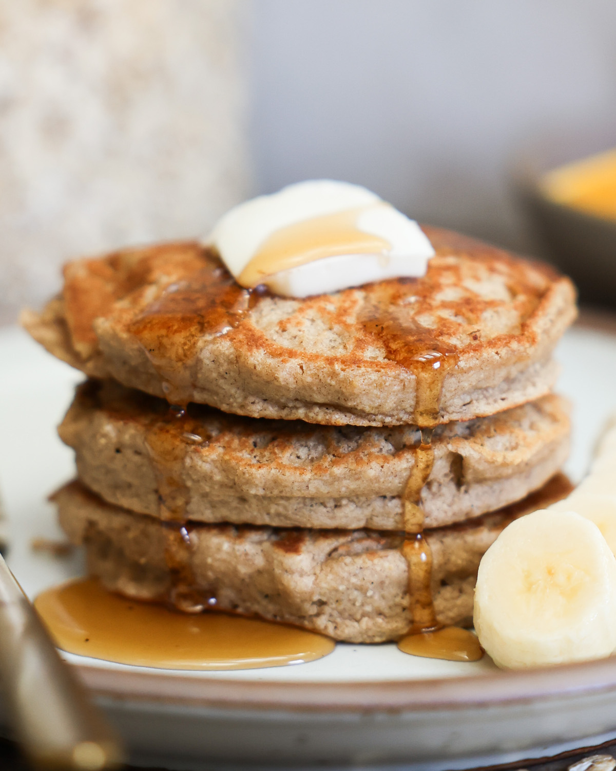 Side view of oat flour pancakes stacked on a plate