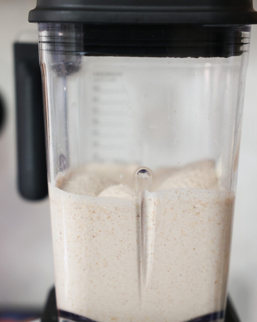 side view of oat flour pancake batter in a blender