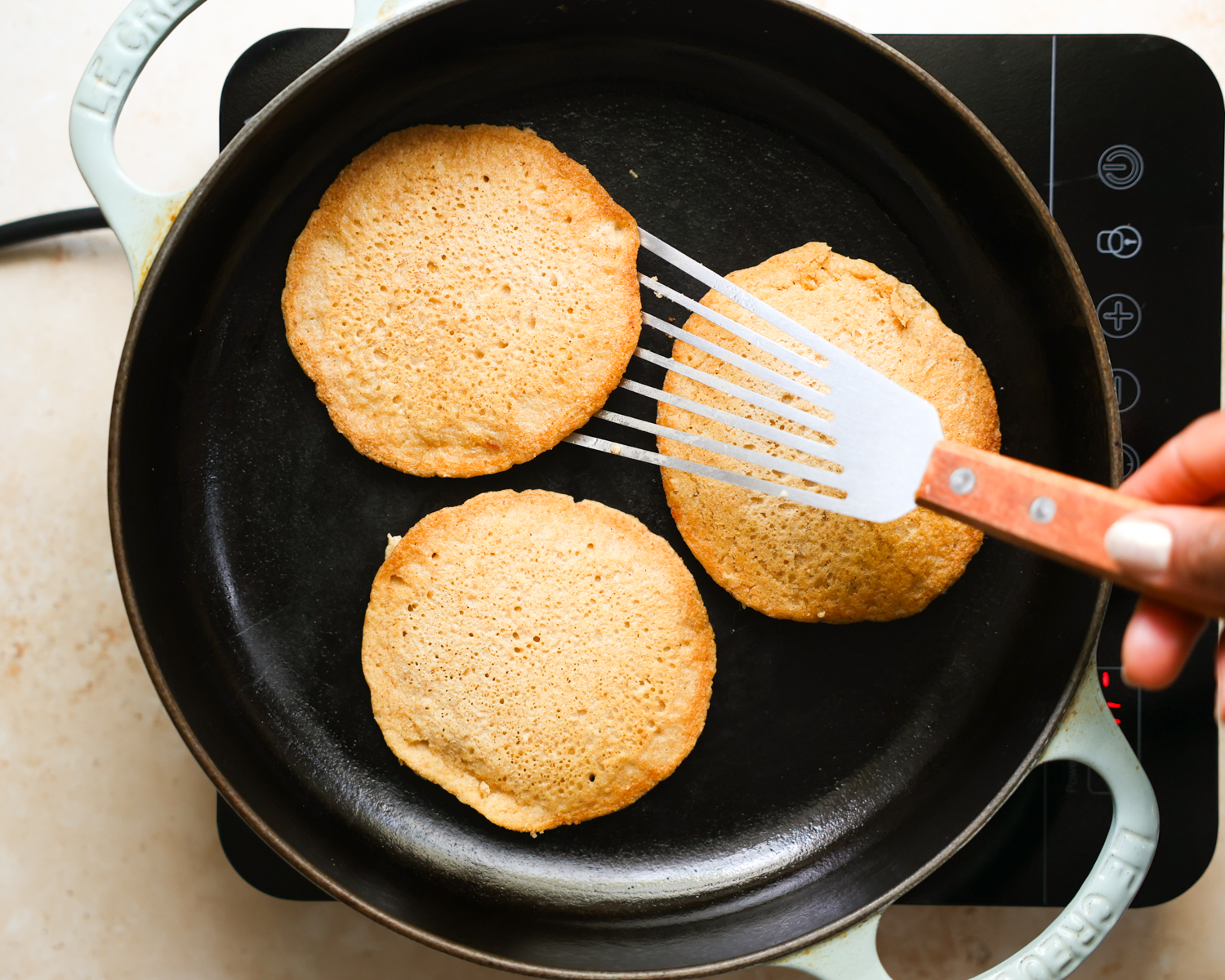 Oat flour pancakes in a skillet.