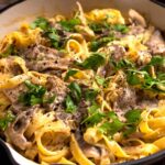 close up of vegan mushroom alfredo in pan