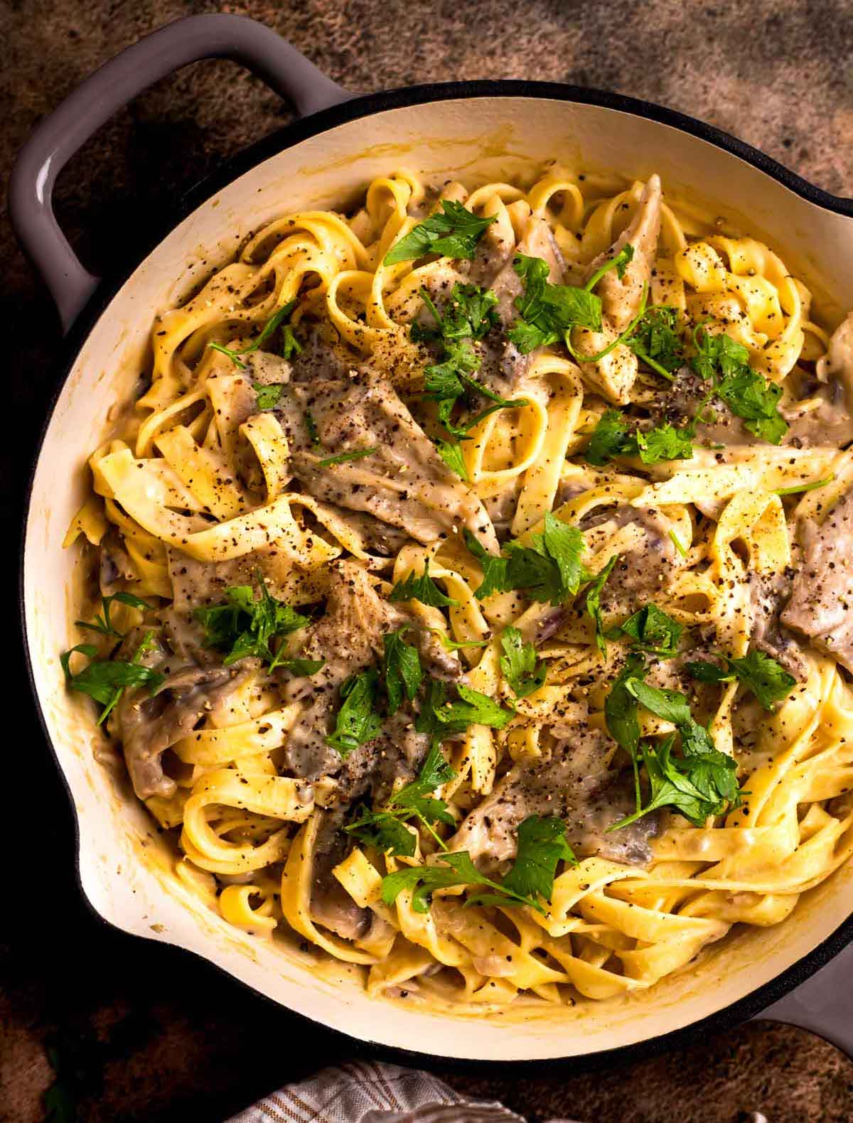 overhead of creamy mushroom alfredo pasta in pot