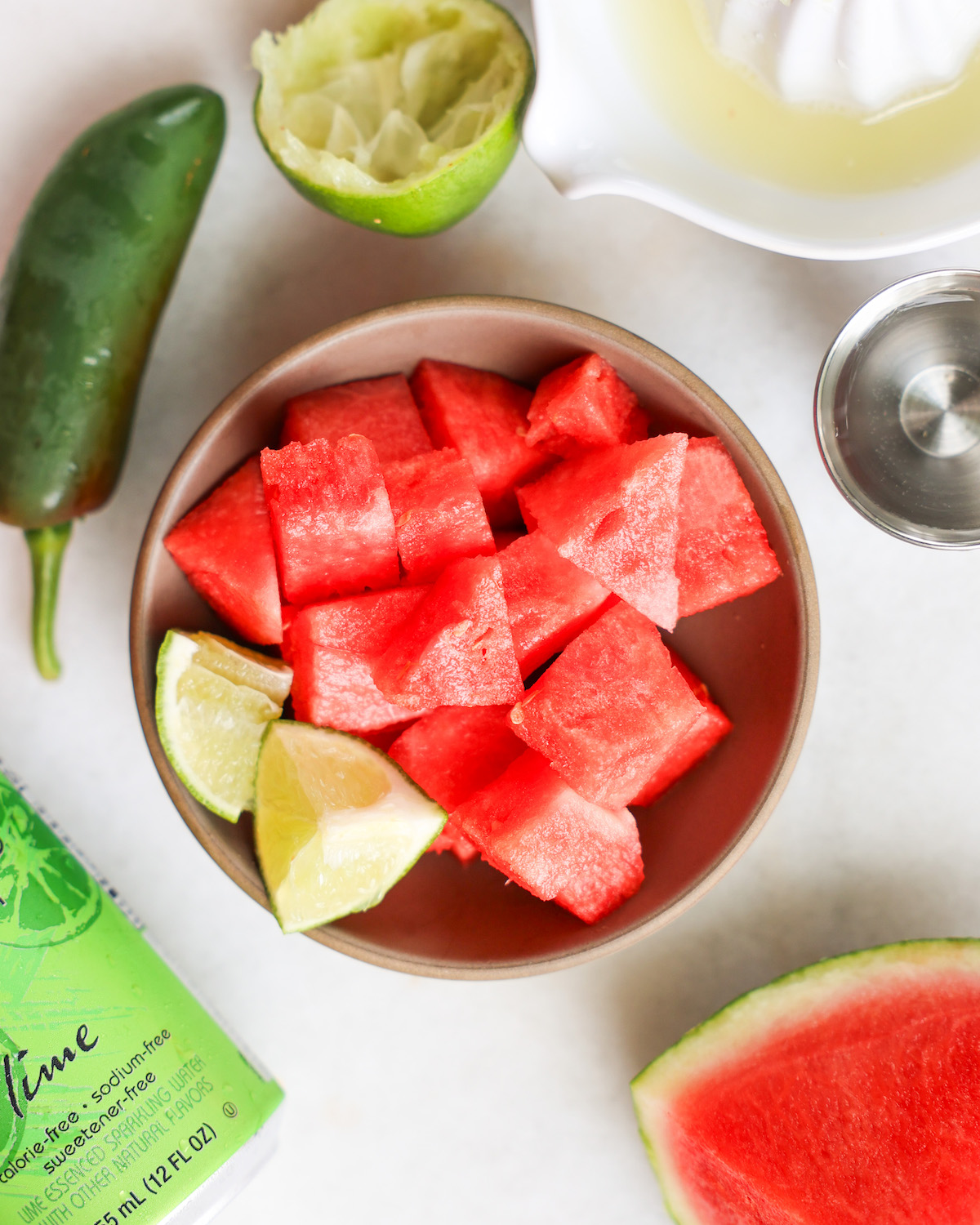 Ingredients for a watermelon margarita on white marble