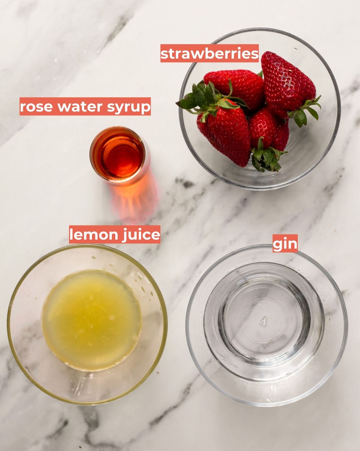 An overhead shot of the ingredients needed to make strawberry rose bramble cocktail.