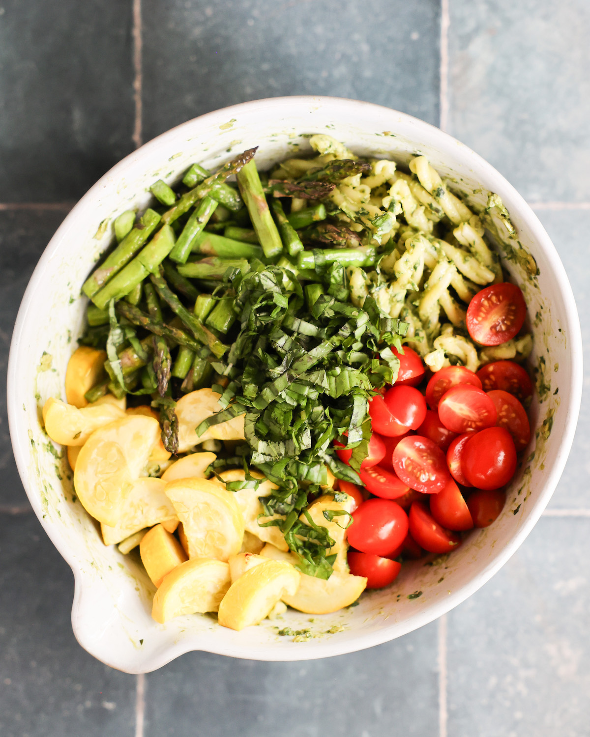 vegan pasta salad ingredients in a mixing bowl