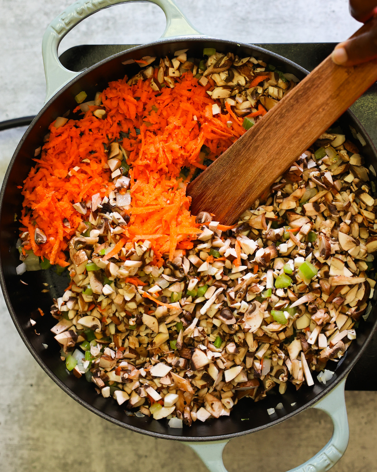 carrots and mushrooms sautéing in a skillet