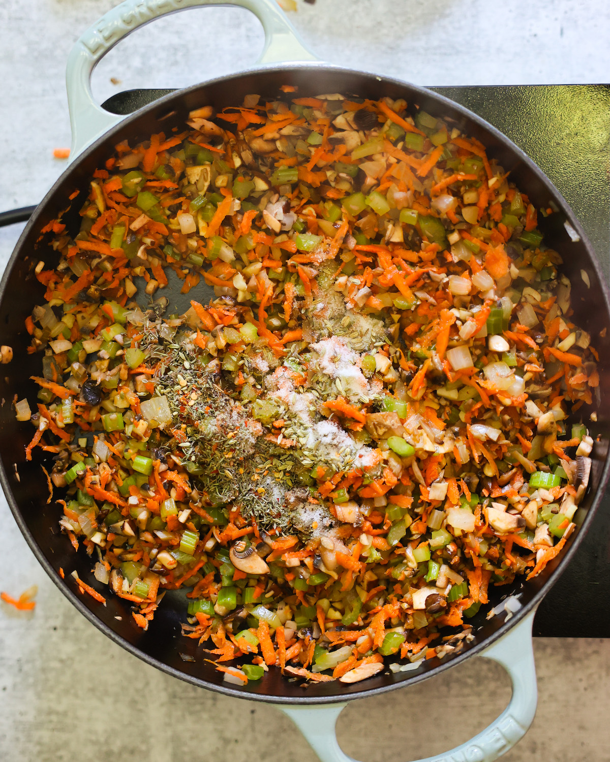 spices added to vegan meatloaf in skillet