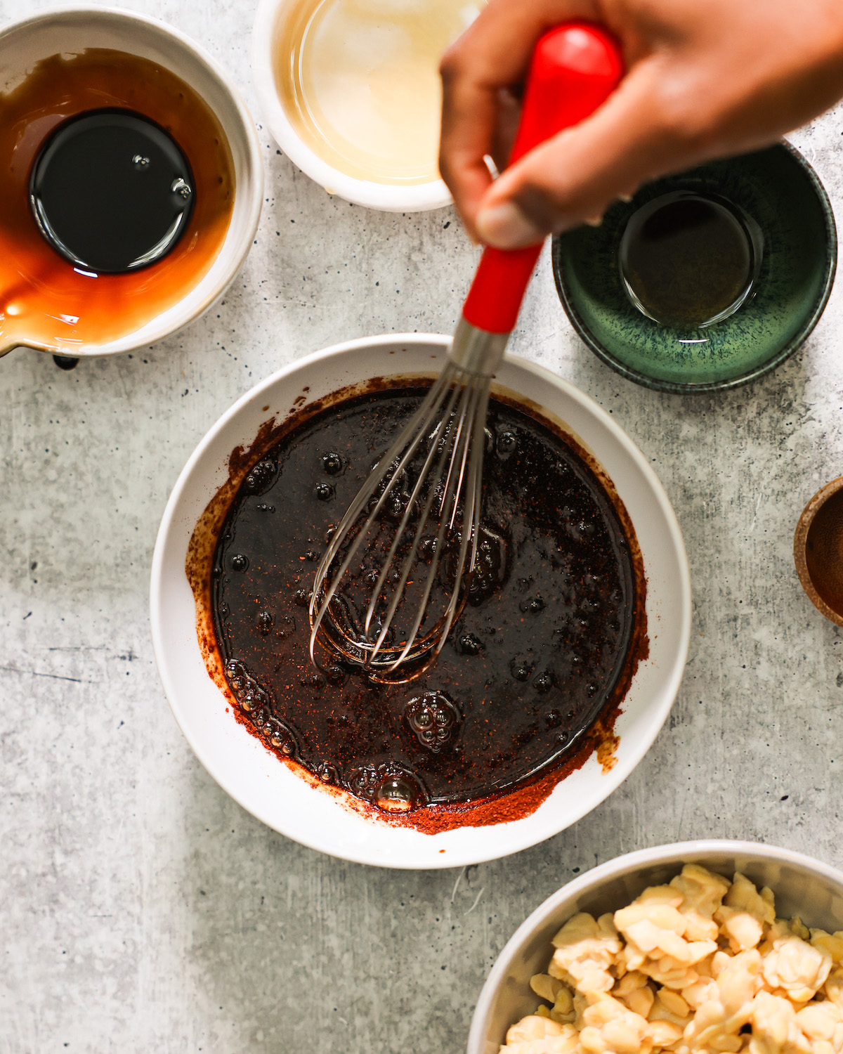 hand whisking marinade for tempeh