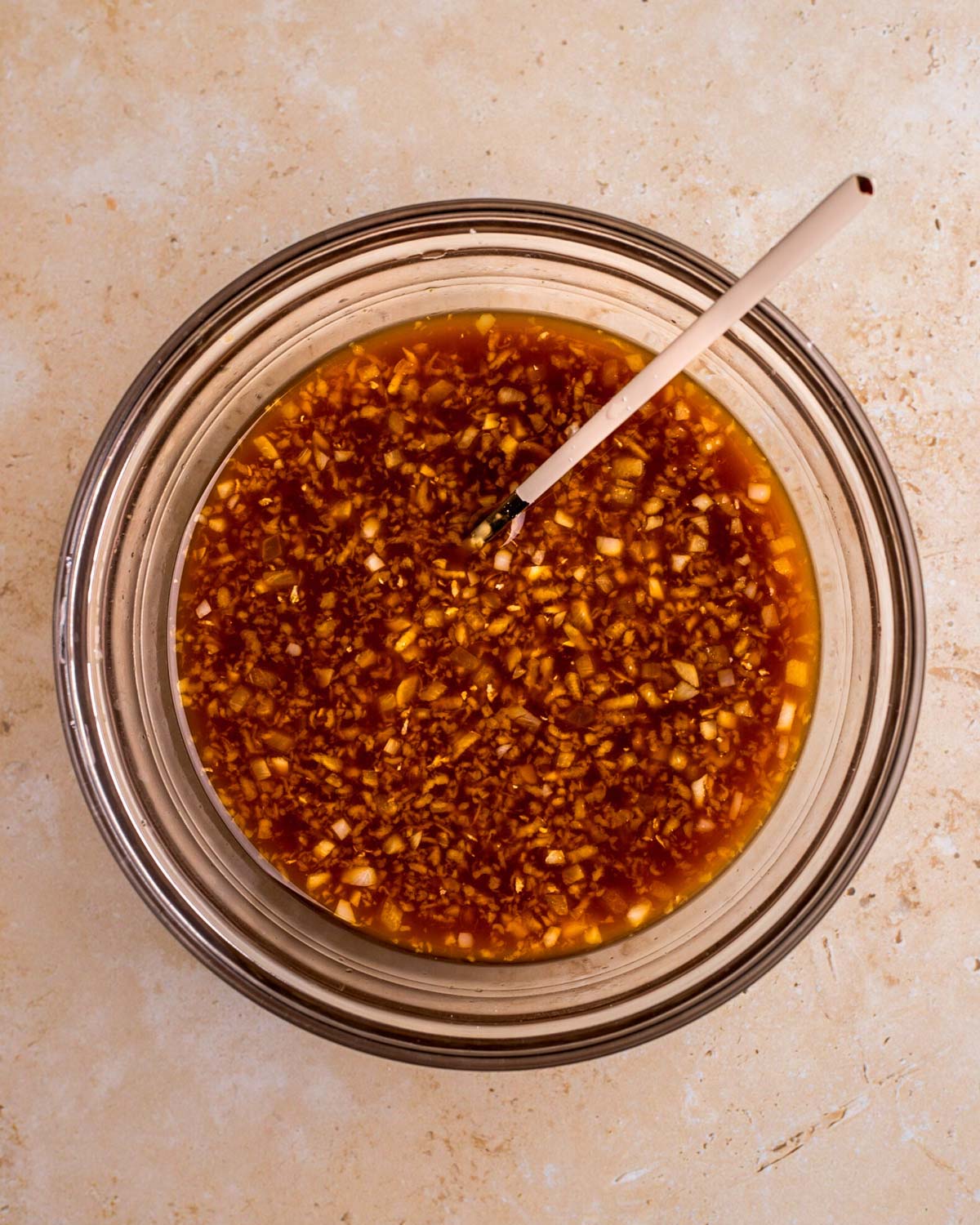 An overhead shot of a small mixing bowl of vegan teriyaki sauce.