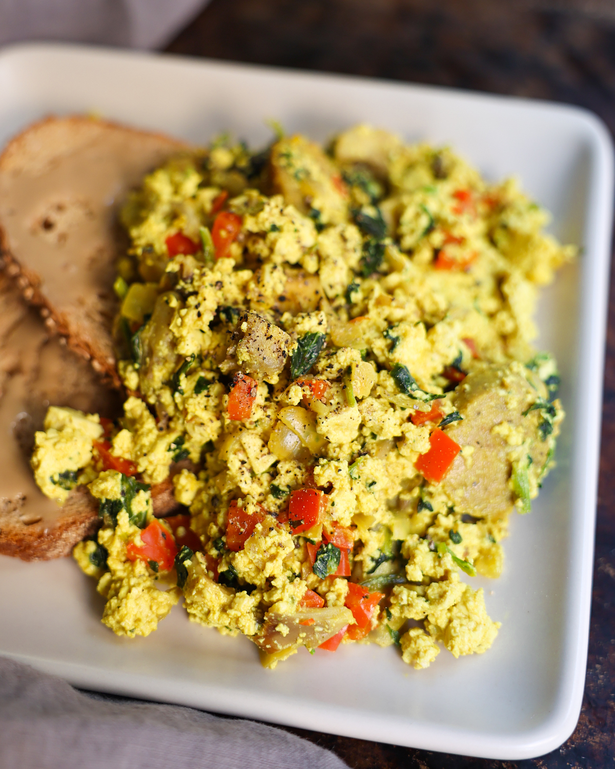 tofu scramble with toast on white plate