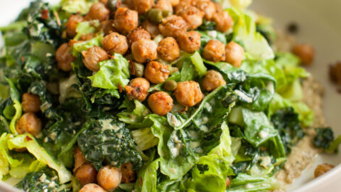 Vegan caesar salad in a white bowl.