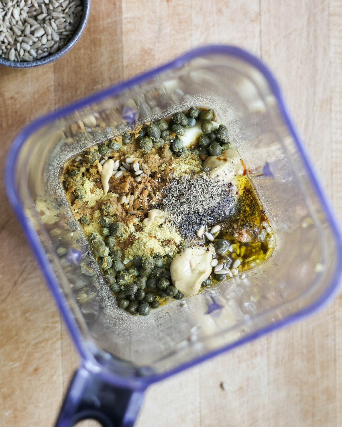 overhead of vegan caesar salad ingredients in a blender