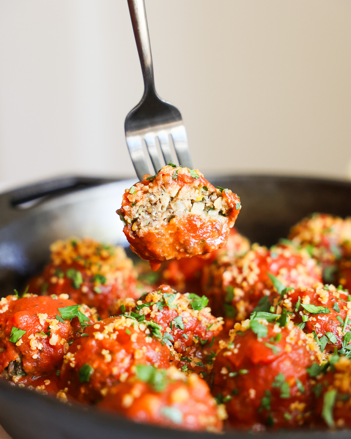 sideview of sliced vegan meatball on fork