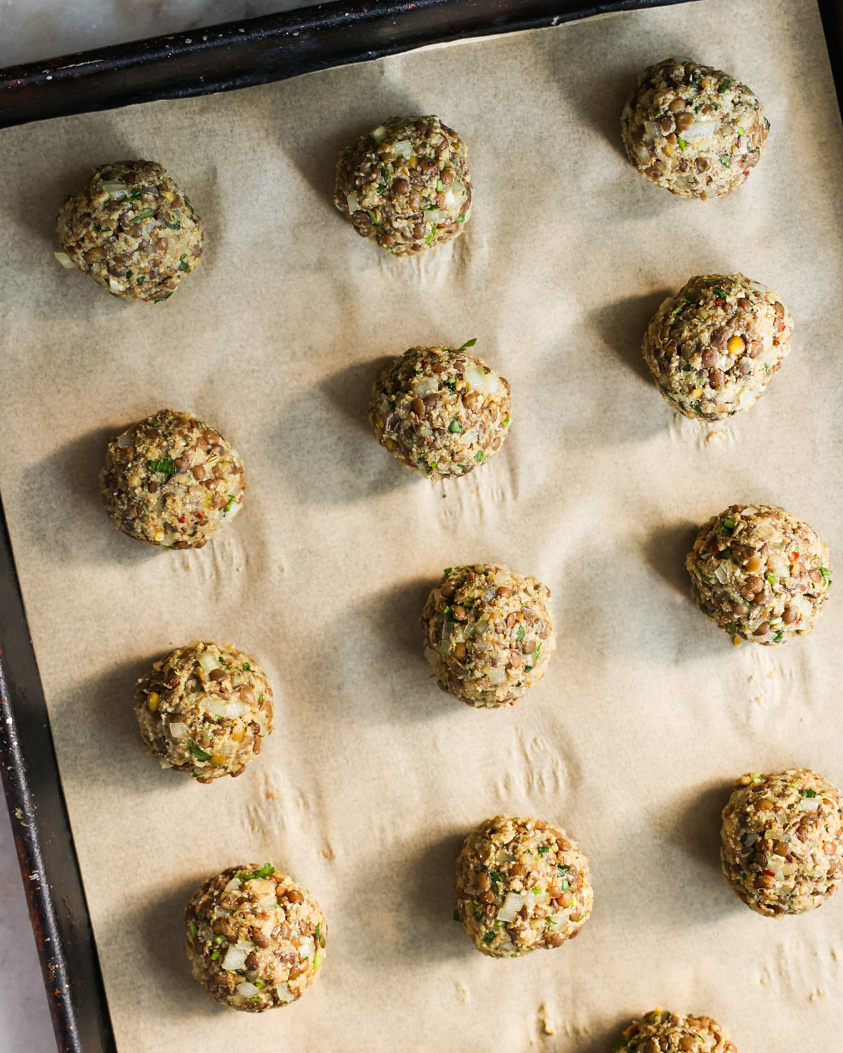 overhead of uncooked vegan meatballs on tray