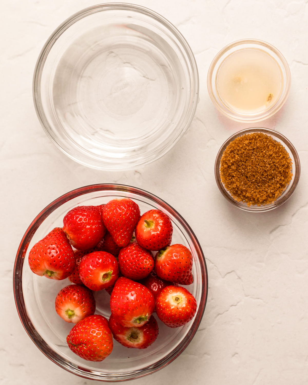 All of the ingredients for strawberry soda on the counter.