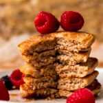 An up-close side shot of a small stack of the pancakes with a forkful taken out of it.