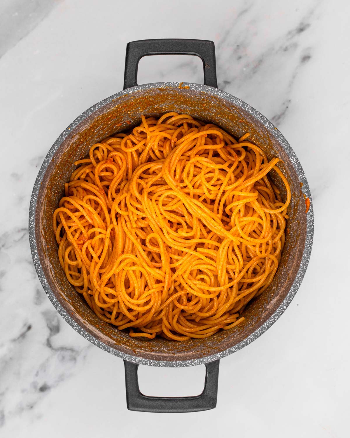 overhead of noodles tossed with gochujang butter sauce