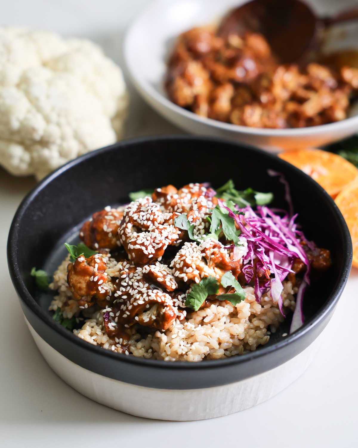 A bowl of orange cauliflower on the counter.