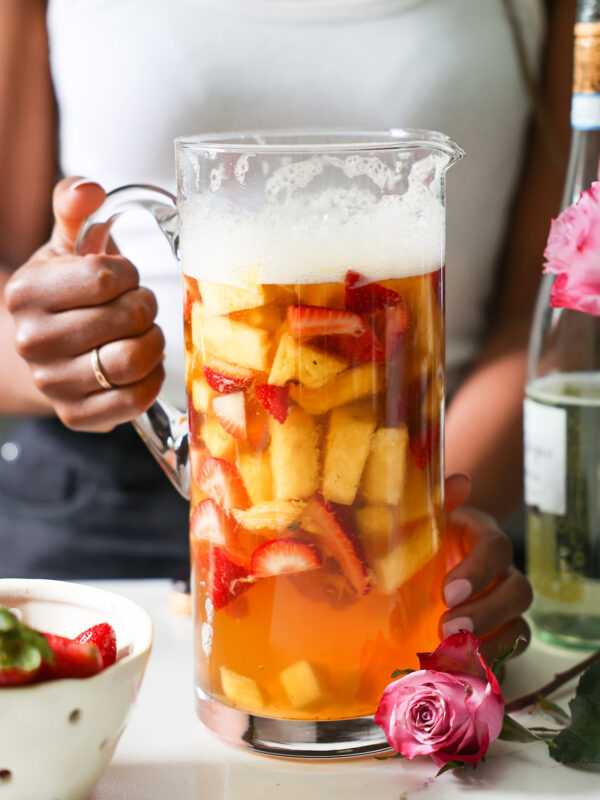 Jenné Claiborne holding a pitcher of white sangira.