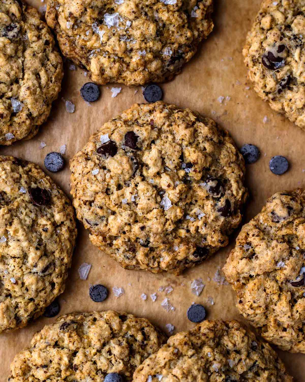 Closeup of Vegan Oatmeal Chocolate Chip Cookies on brown parchment