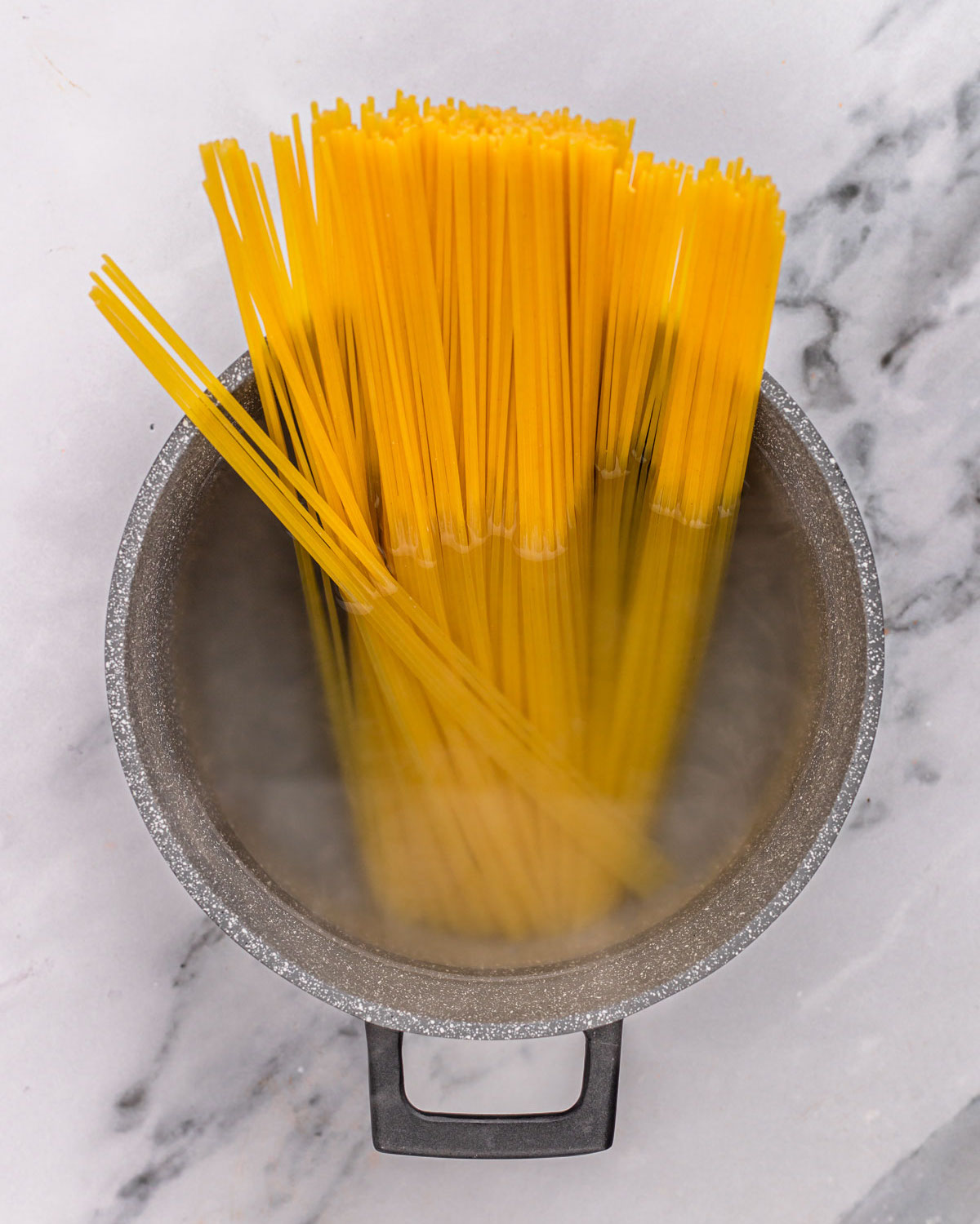 overhead of pasta cooking in pot