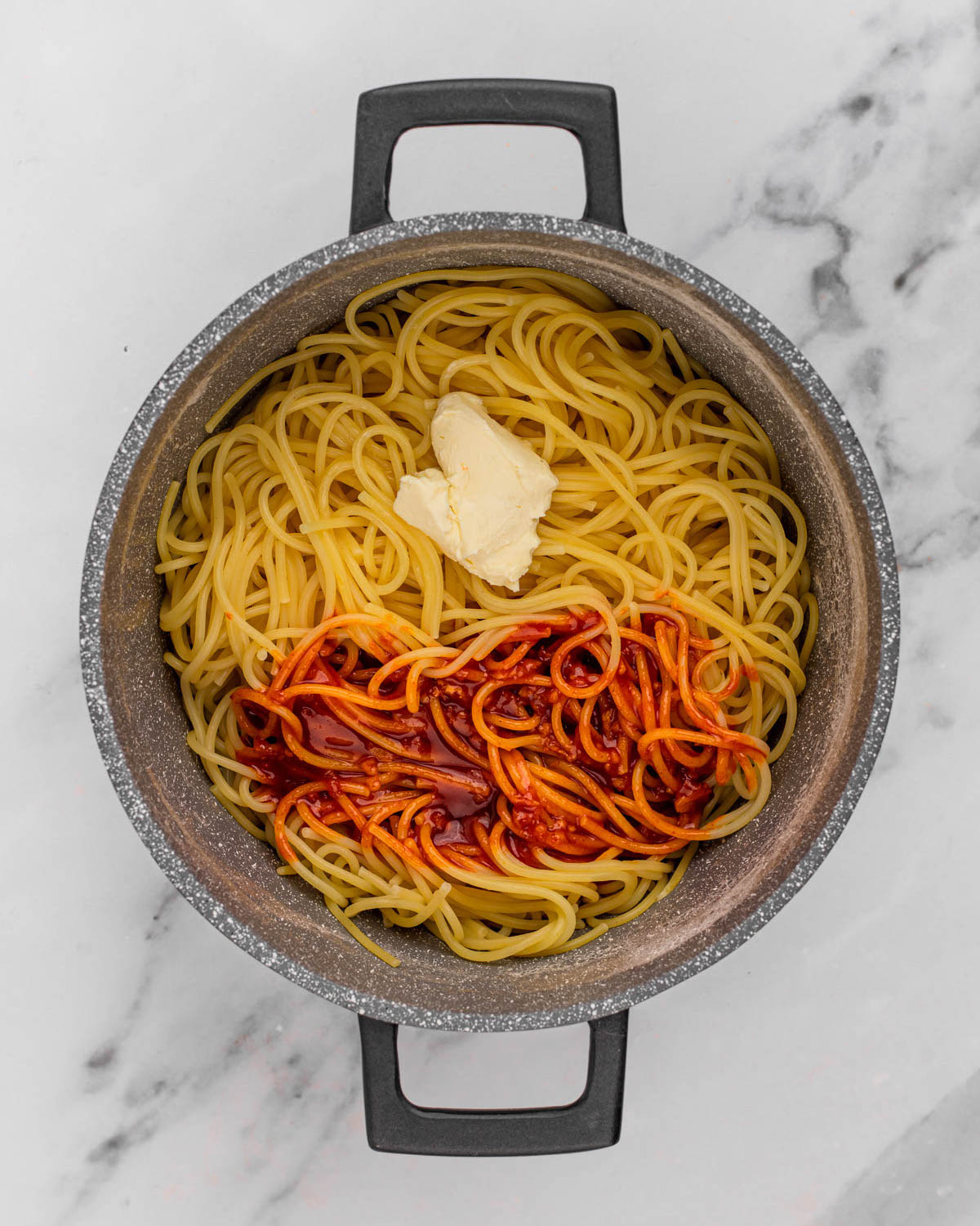 overhead of vegan butter and gochujang sauce on noodles