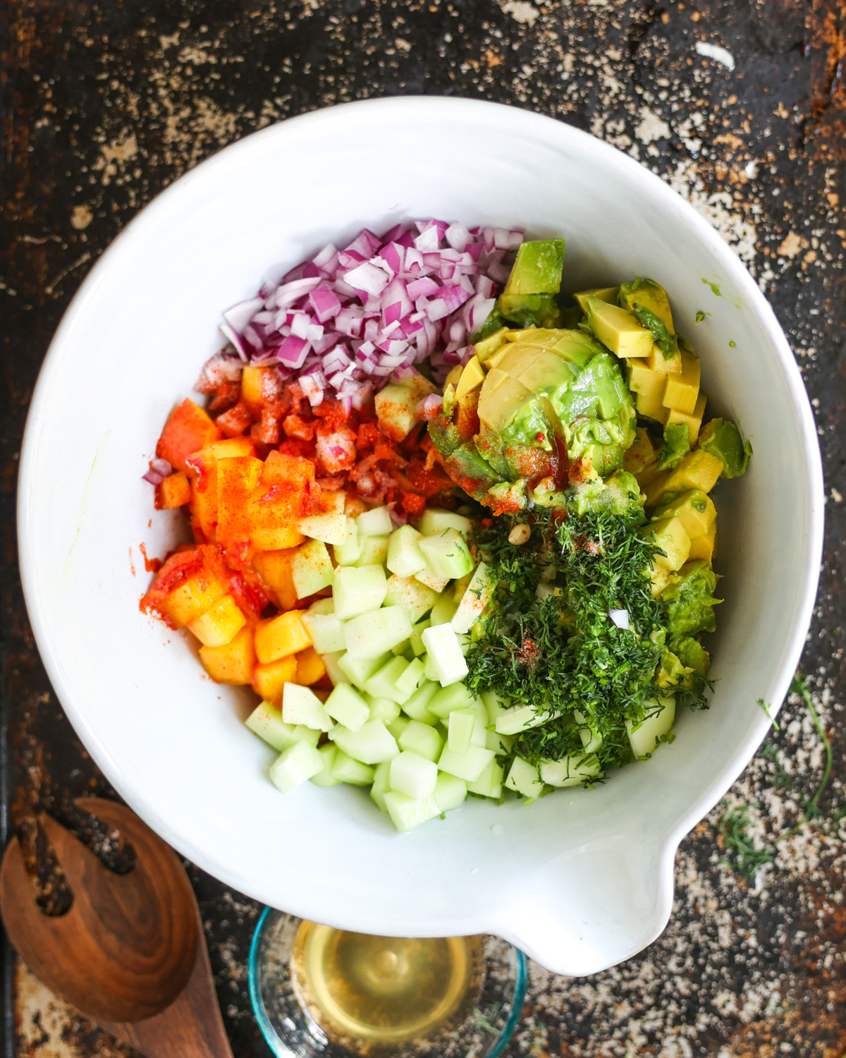 overhead of cucumber avocado salad ingredients in bowl