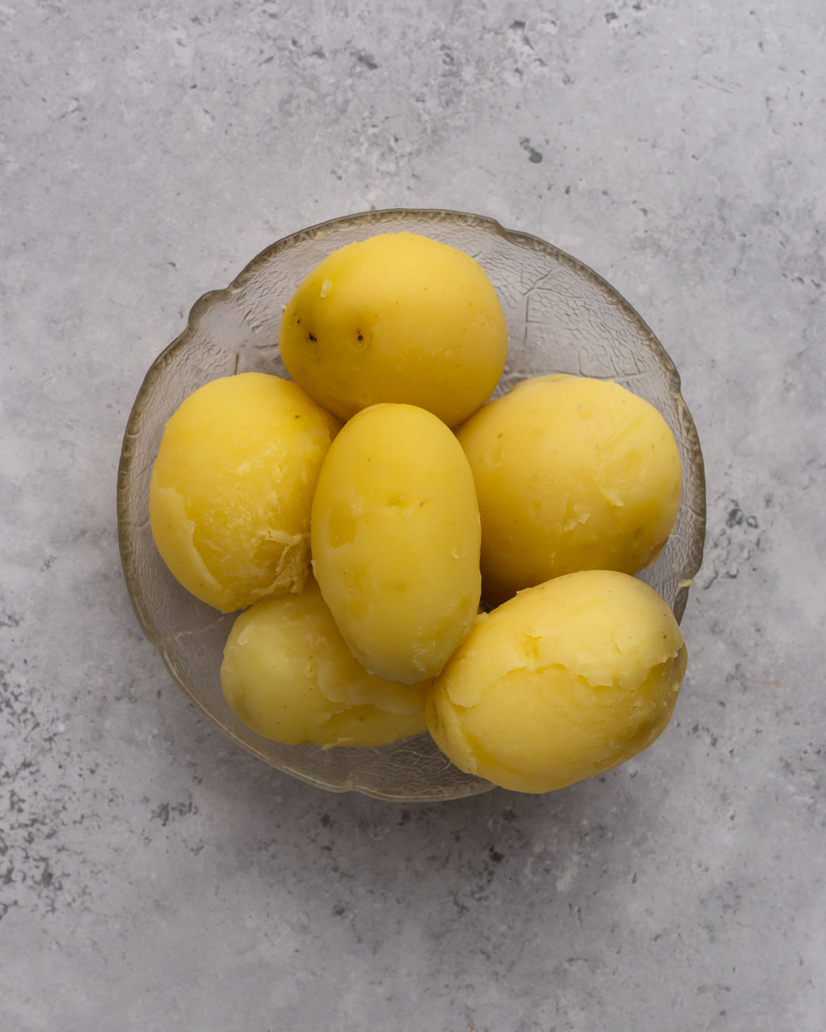 cooked and peeled potatoes in a bowl