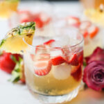 A close up shot of a small cup of pineapple summer sangria on the counter.