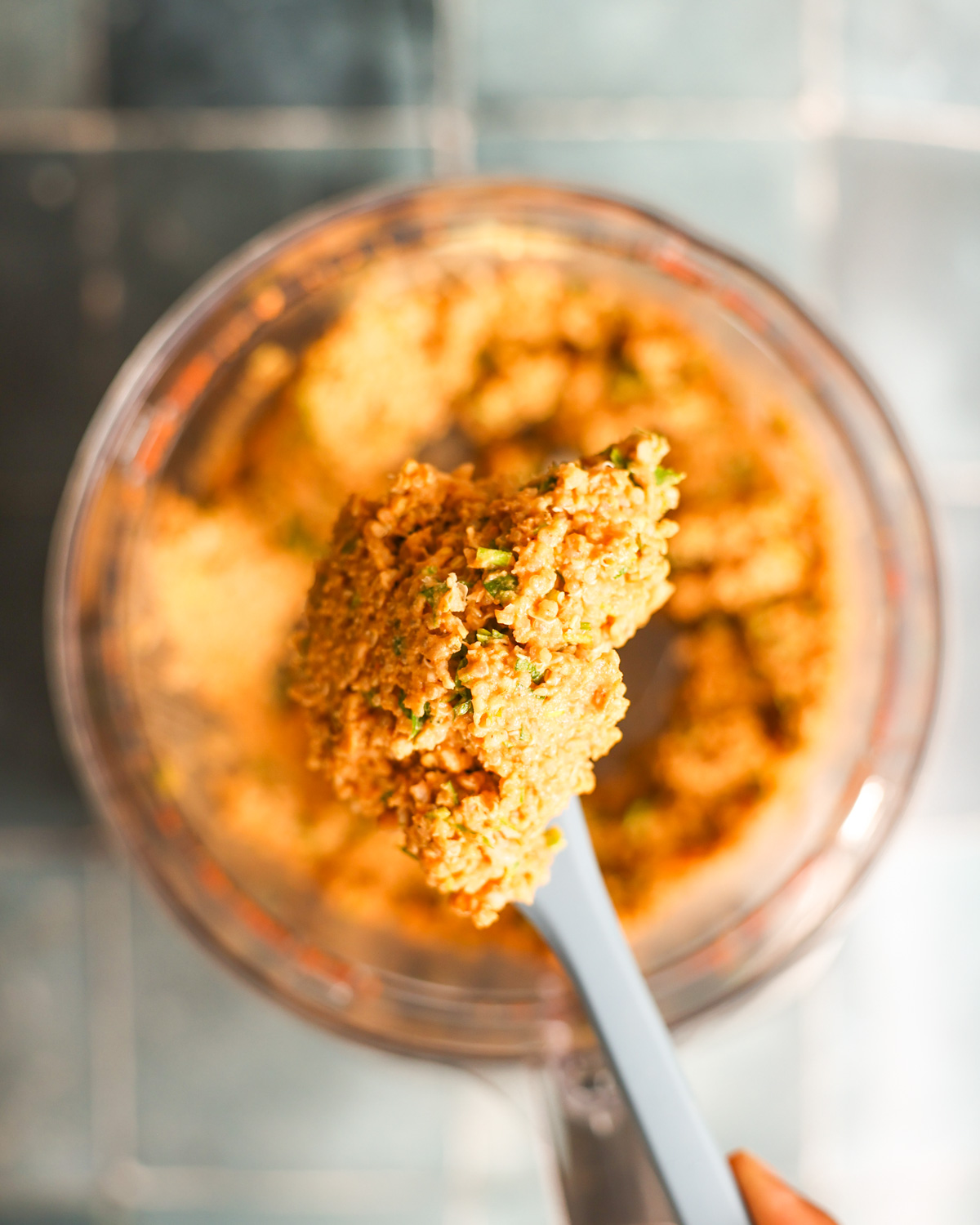 close up of zucchini burger batter on a spatula