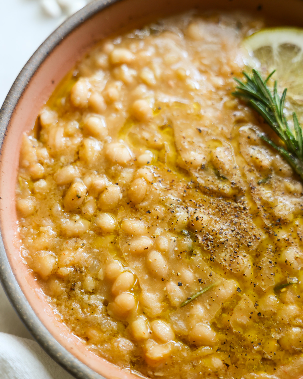 A close-up shot of the instant pot white beans in a bowl.