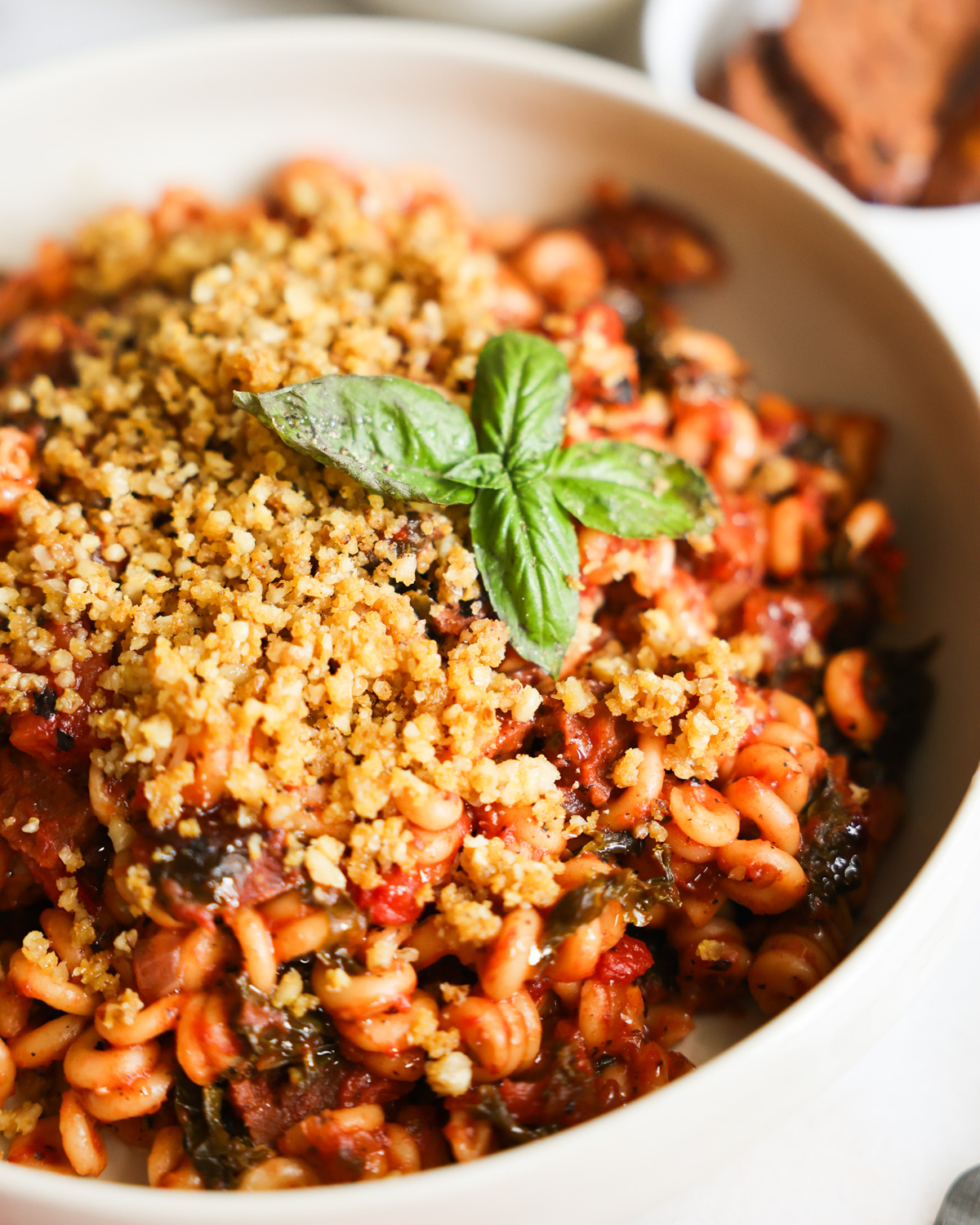 A closeup shot of a white bowl of Instant Pot Vegan Sausage Pasta.