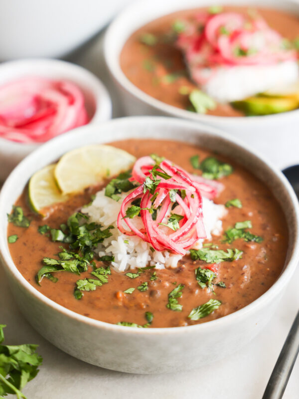 Black bean soup topped with colorful garnish.