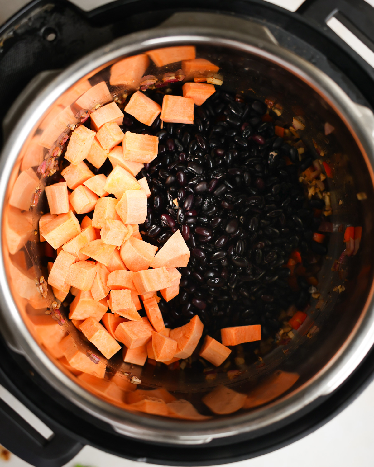 overhead of black beans and sweet potato in pot