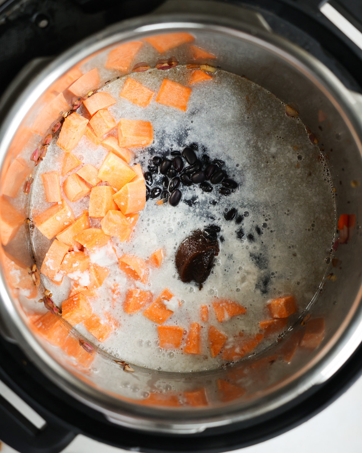 overhead of coconut milk added to pot