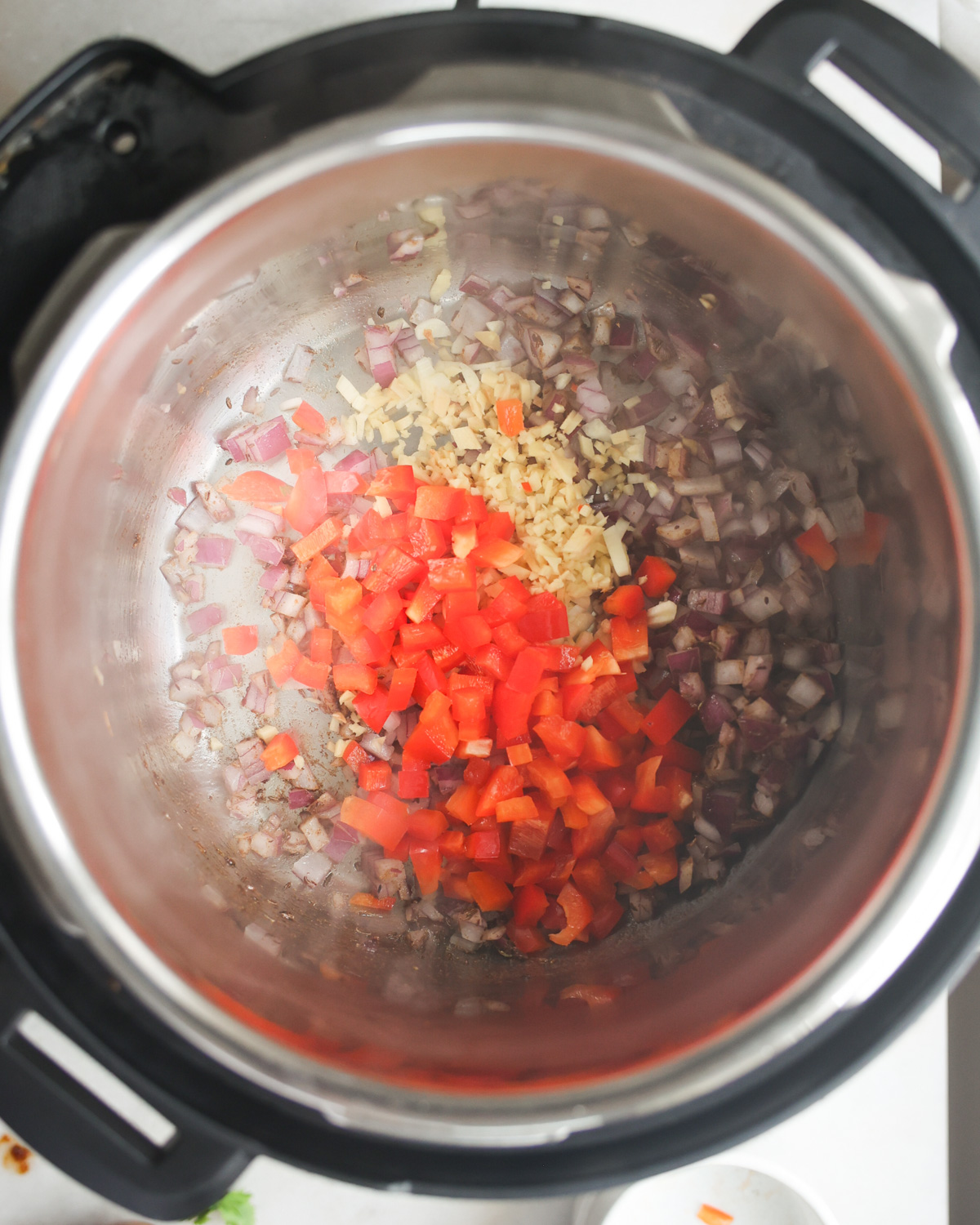 overhead of vegetables sautéing in pot