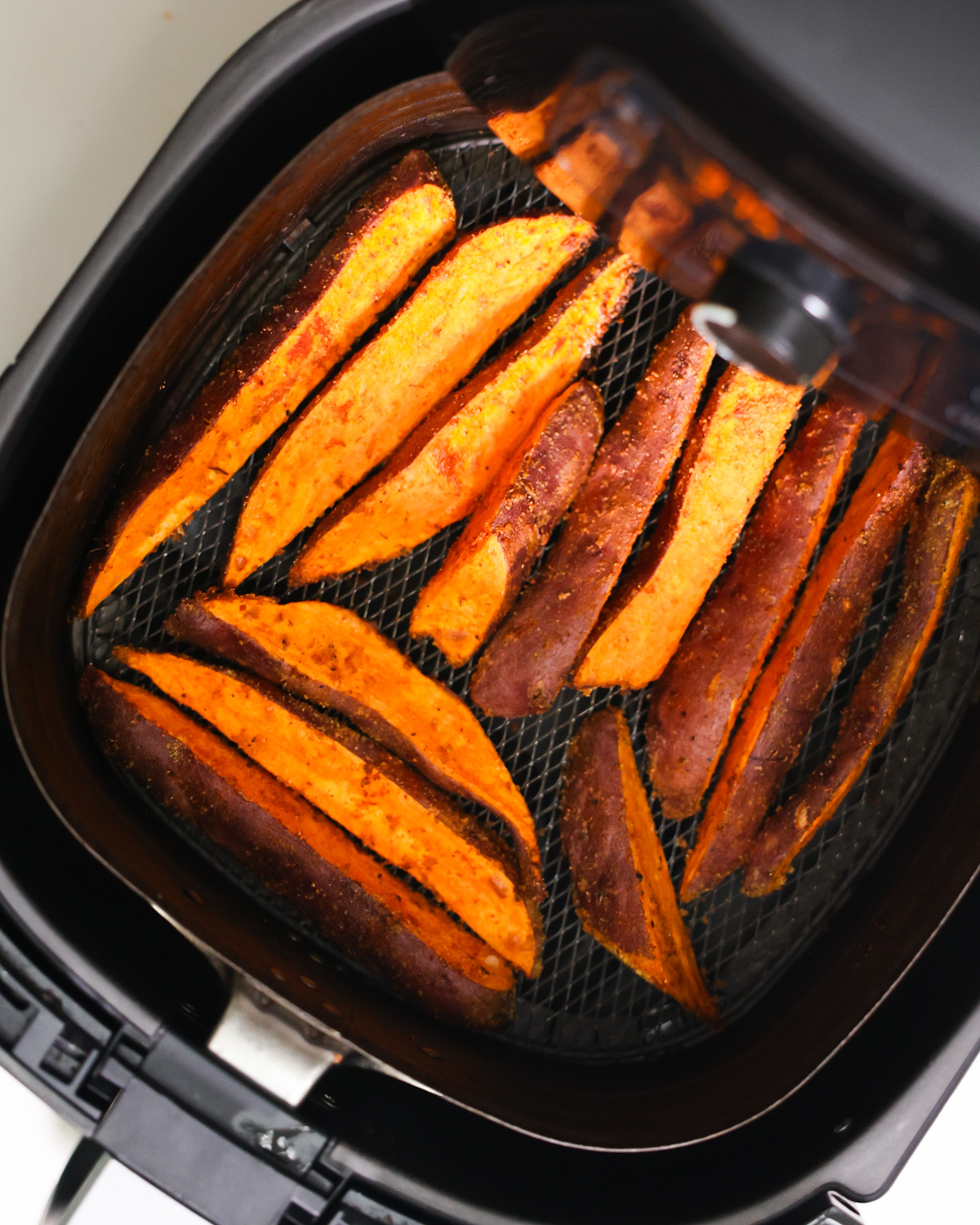 overhead of air fryer sweet potato wedges in air fryer