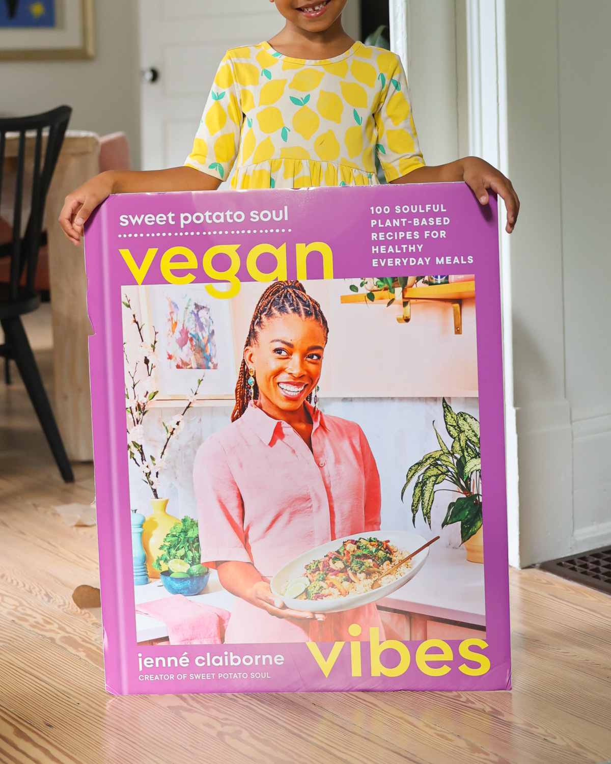 baby holding cookbook poster