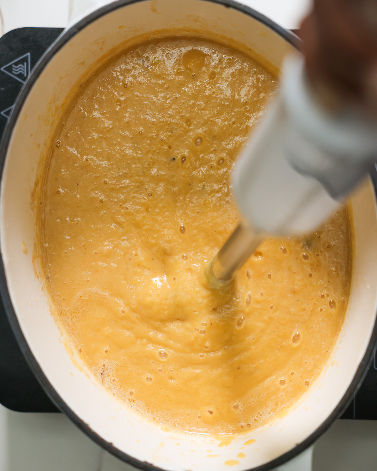 overhead of immersion blender blending soup